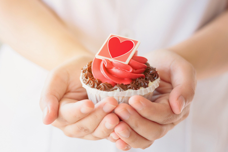 hand hold valentines cupcakeの写真素材