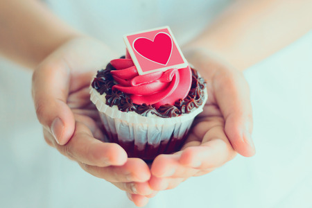 hand hold valentines cupcakeの写真素材