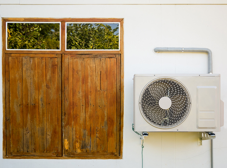 outdoor air conditioning unit on the wallの写真素材