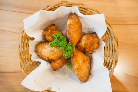 hot and spicy chicken wings in basketの写真素材