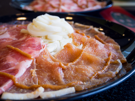 Sukiyaki or Shabu shabu Fresh pork slices on plate ready to cookingの写真素材