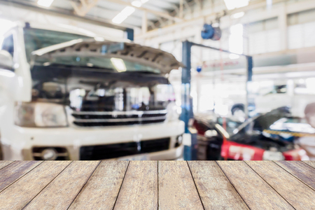 car service centre blurred background with wood tableの写真素材