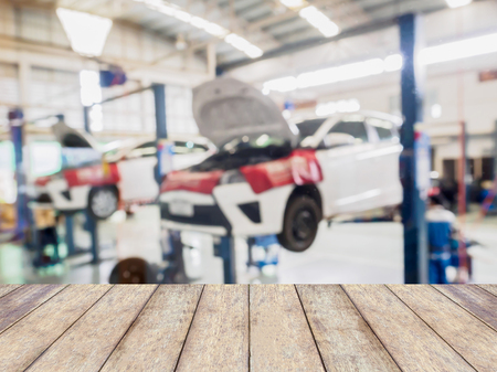 car service centre blurred background with wood tableの写真素材