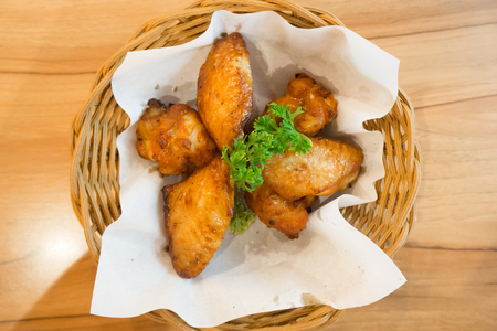 hot and spicy chicken wings in basketの写真素材