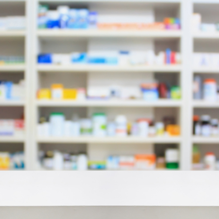 Pharmacy counter store table background with medicine shelves in drugstoreの写真素材