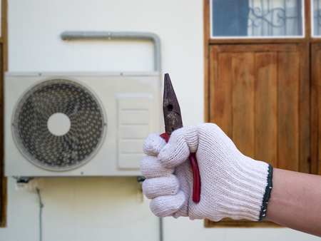 technician installing outdoor air conditioning unitの写真素材
