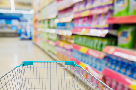 shopping cart with supermarket blur backgroundの写真素材