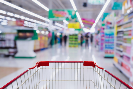 Supermarket store abstract blur background with shopping cartの写真素材