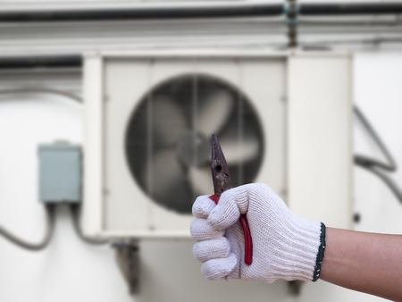 technician installing outdoor air conditioning unitの写真素材