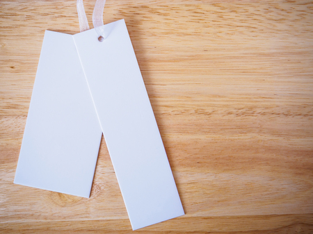 blank white price label on wood backgroundの写真素材
