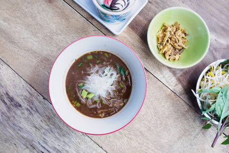 Noodles Soup with Meat Thai food on wood tableの写真素材