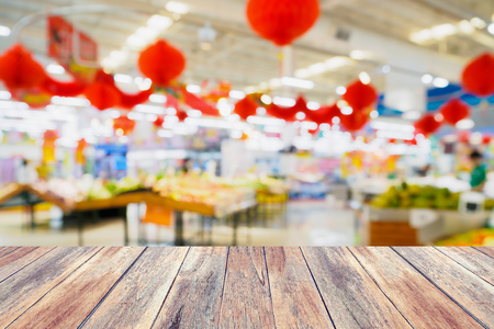 wood table with abstract supermarket blurred backgroundの写真素材