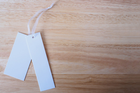 blank white price label on wood backgroundの写真素材