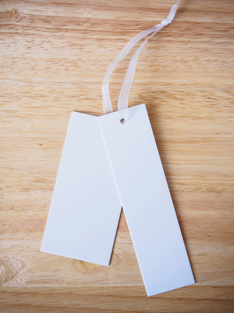blank white price label on wood backgroundの写真素材