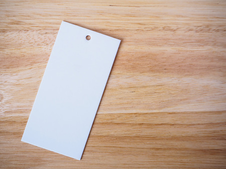blank white price label on wood backgroundの写真素材