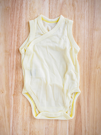 newborn baby clothes on wood backgroundの写真素材