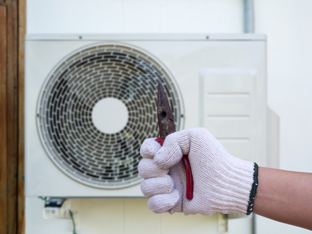 technician installing outdoor air conditioning unitの写真素材