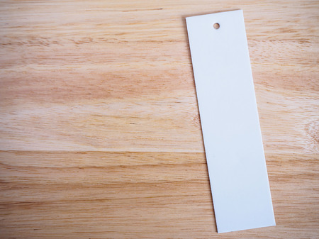 blank white price label on wood backgroundの写真素材