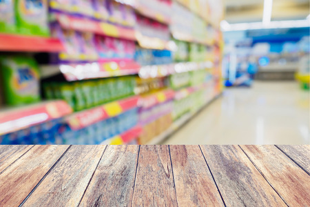 wood table with shelves in supermarket blurred backgroundの写真素材