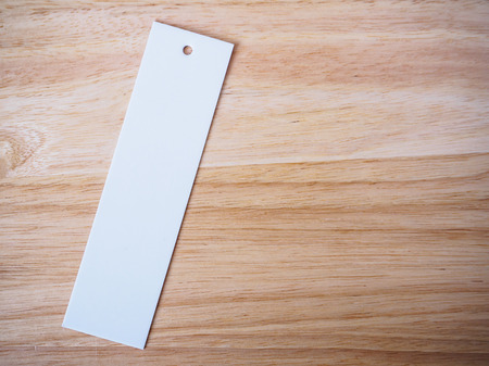 blank white price label on wood backgroundの写真素材