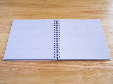 open notebook on wood table backgroundの写真素材