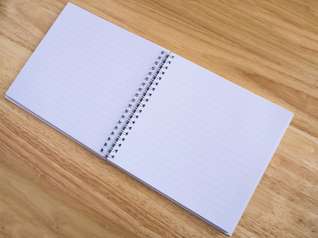 open notebook on wood table backgroundの写真素材