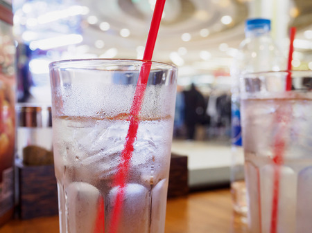 glass of water on wood table in restaurantの写真素材