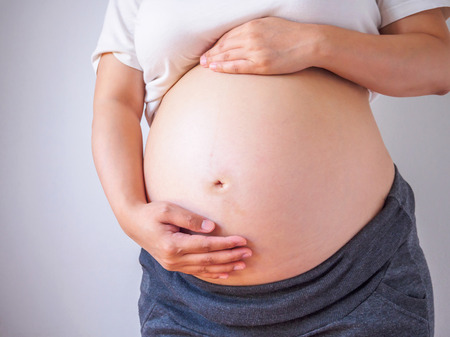pregnant woman touching her bellyの写真素材