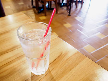 glass of water on wood table in restaurantの写真素材