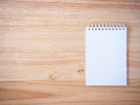 Notepad on the wooden desk tableの写真素材