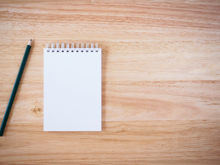 Pencil and Notepad on the wooden desk tableの写真素材