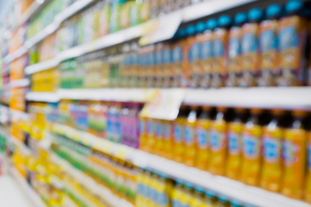 blur drinks bottles product on shelves in supermarket for backgroundの写真素材