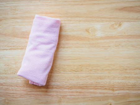 newborn baby clothes on wood backgroundの写真素材
