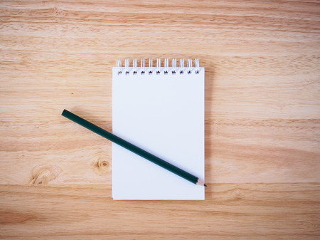 Pencil and Notepad on the wooden desk tableの写真素材