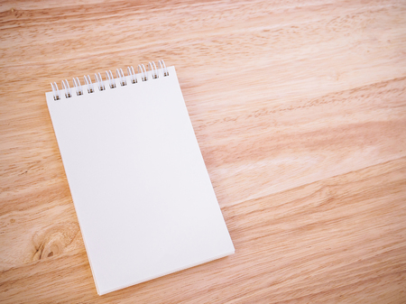 Notepad on the wooden desk tableの写真素材