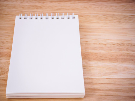 Notepad on the wooden desk tableの写真素材