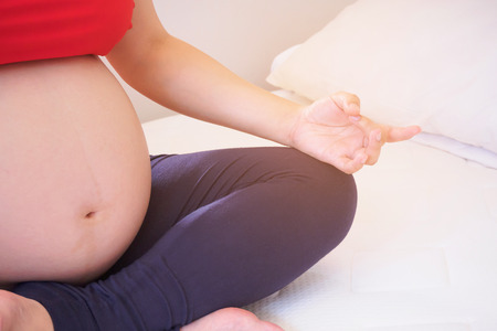 pregnant woman doing yogaの写真素材