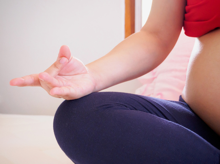 pregnant woman doing yogaの写真素材