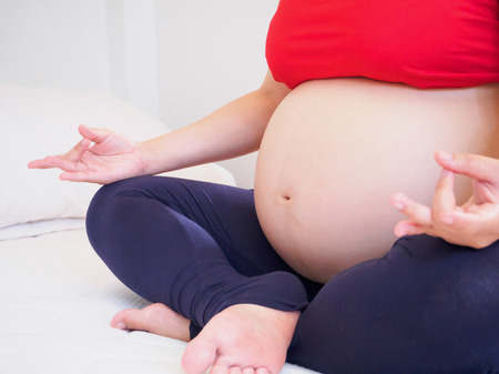 pregnant woman doing yogaの写真素材