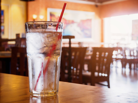 glass of water on wood table in restaurantの写真素材
