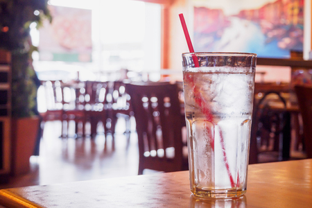 glass of water on wood table in restaurantの写真素材