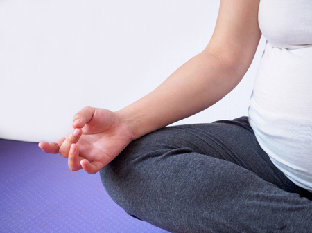 pregnant woman doing yoga at homeの写真素材