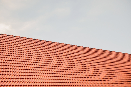 house roof tiles with clouds and skyの写真素材