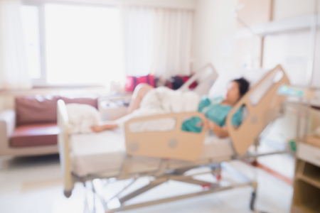 Abstract blur Patient on bed in Hospital Room interior for backgroundの写真素材