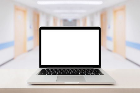 Laptop computer on medical table with hospital backgroundの写真素材