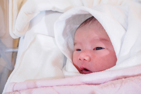 Cute newborn asian baby girlの写真素材