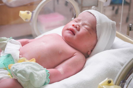 new born baby infant sleep in the incubator at hospitalの写真素材
