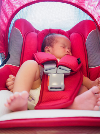 newborn baby sit in the car seat for safetyの写真素材