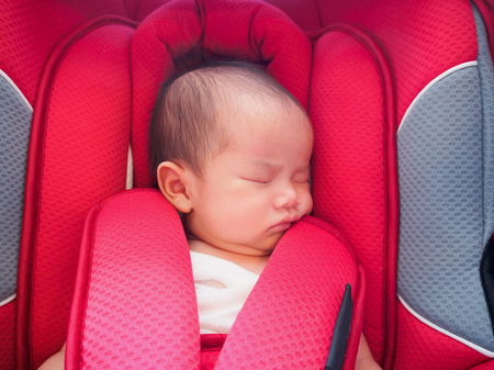newborn baby sit in the car seat for safetyの写真素材