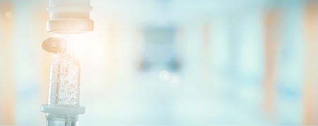 Medical drip with hospital blurred backgroundの写真素材